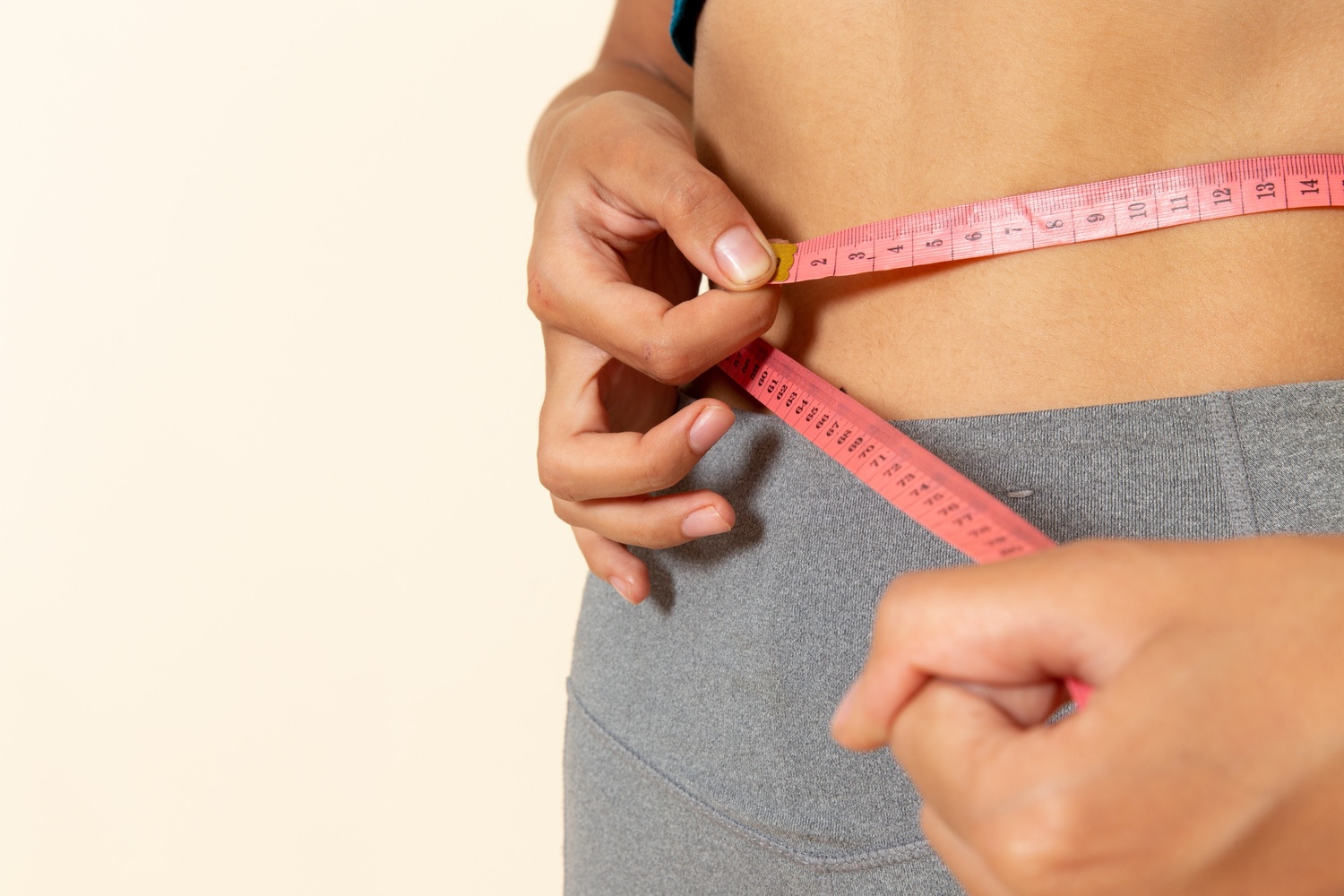 female-measuring-her-waist