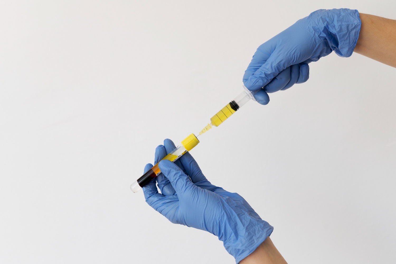 hands-with-gloves-holding-injection